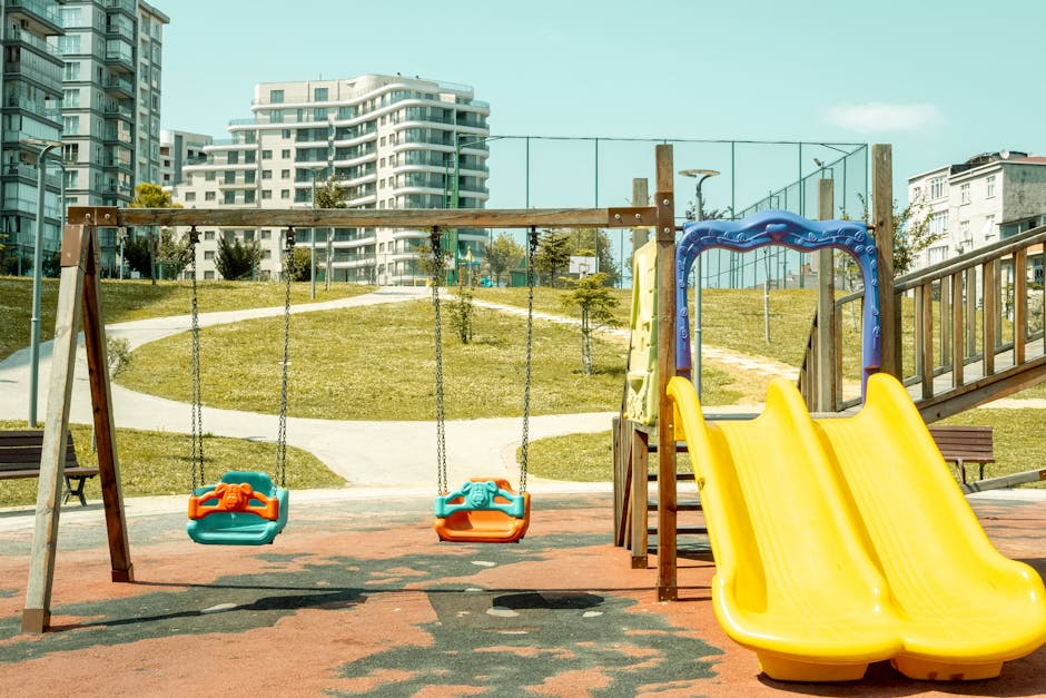 Colorful playground with swings and slide, perfect for outdoor fun and leisure.